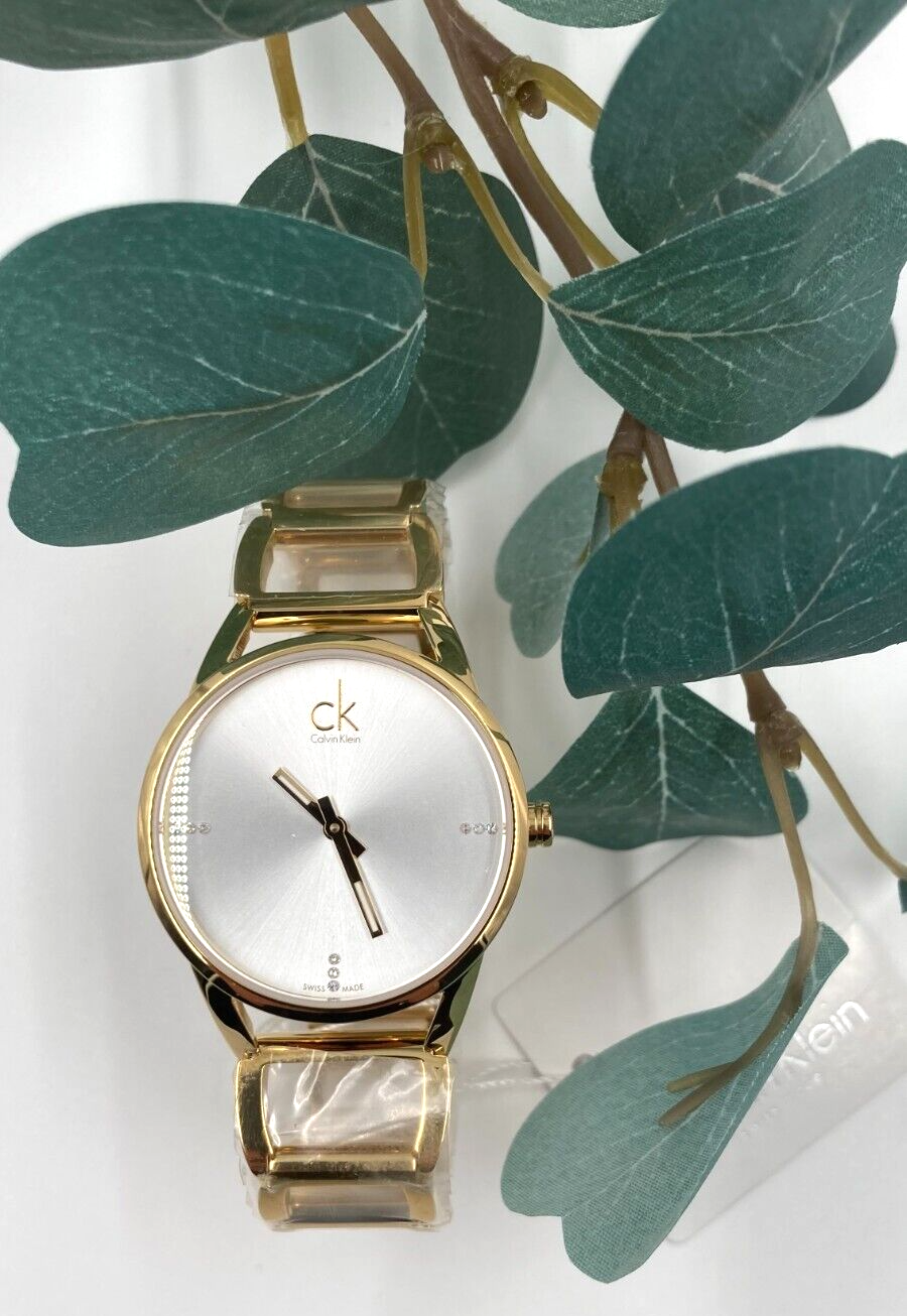 CALVIN KLEIN Quarz Damenarmbanduhr silbernes Zifferblatt gelbgoldene Beschichtung